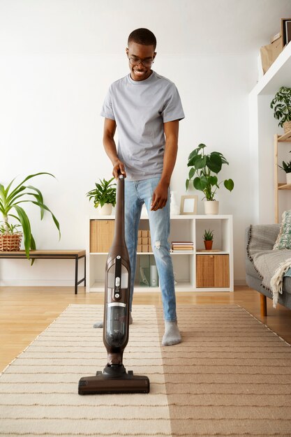 Man vacuuming floor front view