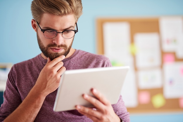 Man very focused on digital tablet
