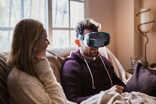 Free photo man in vr glasses sitting near woman