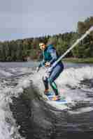 Free photo man on wakesurfing. wave from the boat.