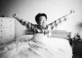 Free photo a man waking up on the bed