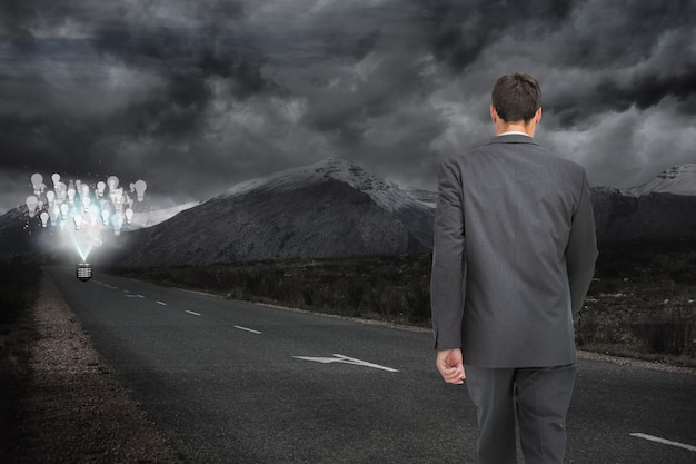 Man walking along a dark road