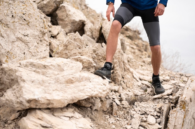 Free photo man walking through rocks in nature