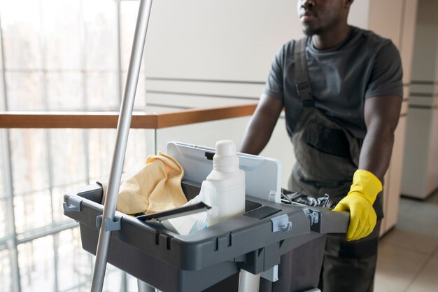 man walking with cleaning cart