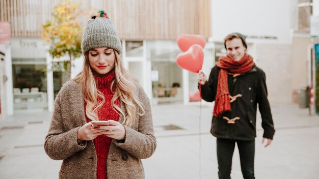 Man walking to woman with balloons