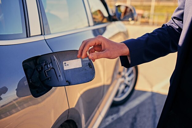 A man wants to open a gasoline tank.