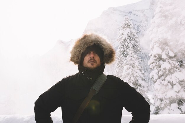 Man in warm clothes on mountains background