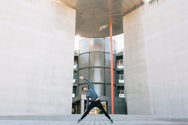 Man warming up before training on street