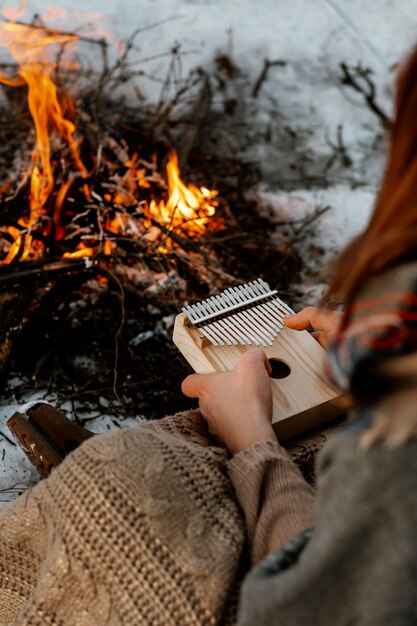 Man warming up next to a campfire in winter