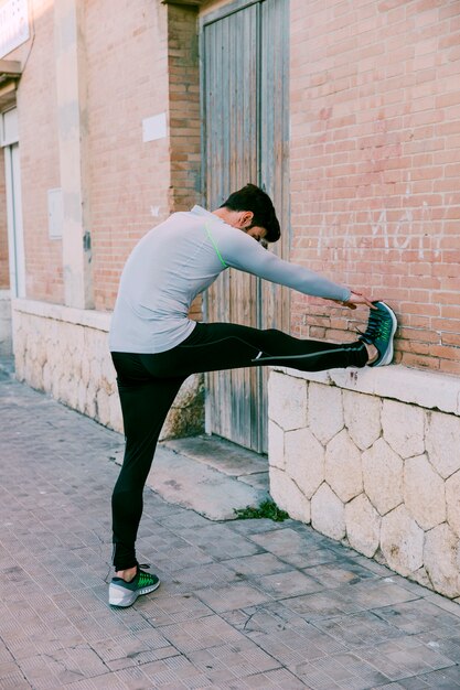 man warming up on street