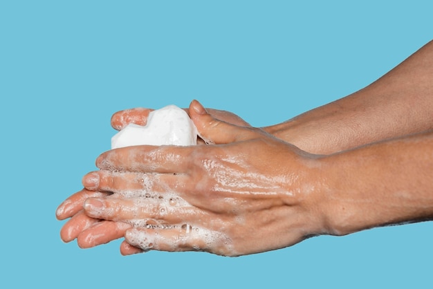 Man washing hands with a white soap