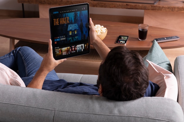 Man watching his favorite movie on a tablet