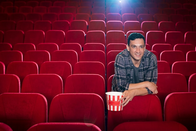 Free photo man watching movie in cinema