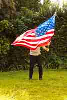 Free photo a man waving armenian flag in park