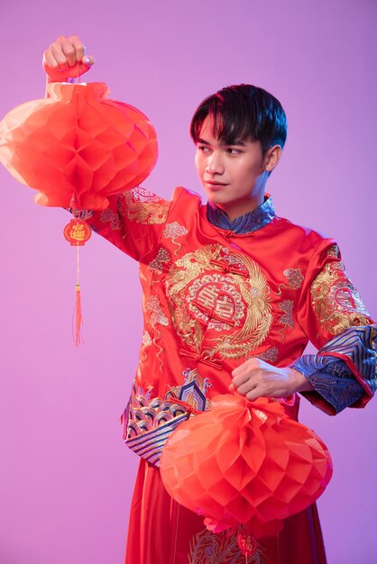 Man wear Cheongsam show decorate red lamp to  shop in chinese new year