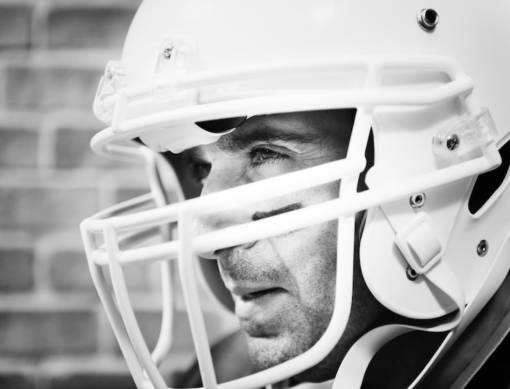 Free Photo man wearing amerian football helmet