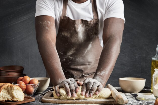 Man wearing apron baking in kitchen
