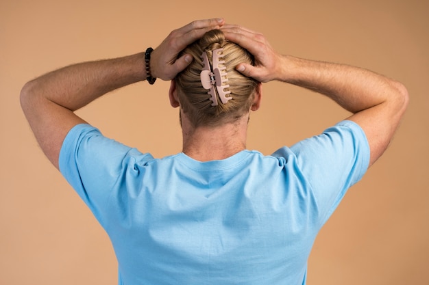 Uomo che indossa un grande fermaglio per capelli vista posteriore