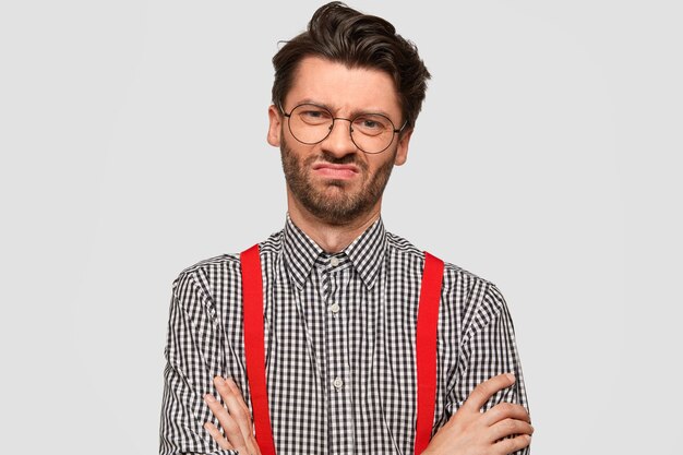 Man wearing checkered shirt and red suspenders