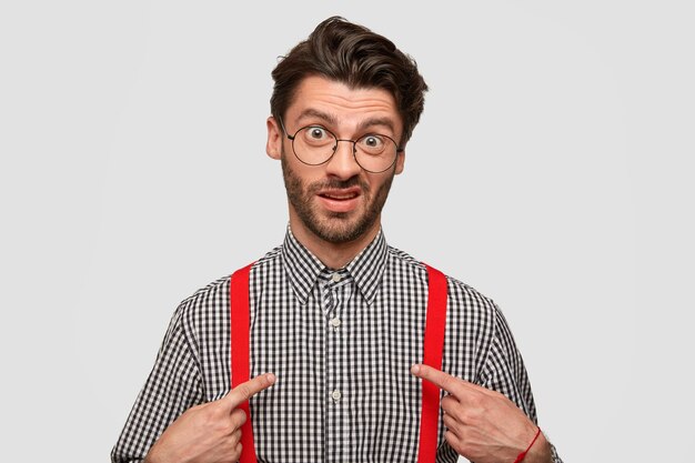 Man wearing checkered shirt and red suspenders