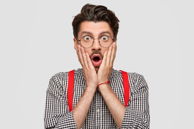 Man wearing checkered shirt and red suspenders