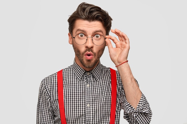 Free photo man wearing checkered shirt and red suspenders