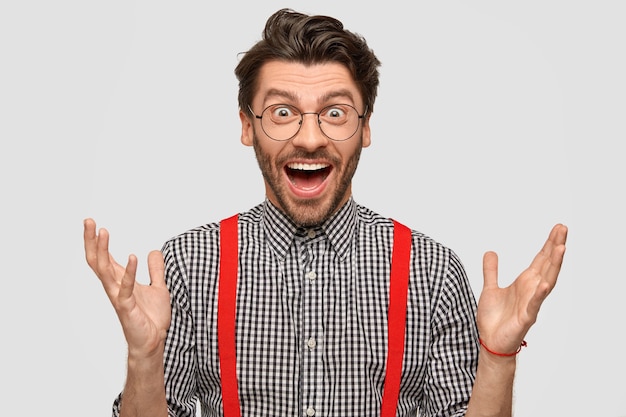 Man wearing checkered shirt and red suspenders