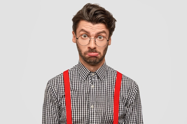 Free photo man wearing checkered shirt and red suspenders