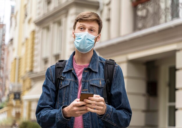 Man wearing a face mask and looking straight forward