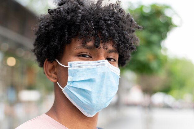 Man wearing face mask outdoors close up