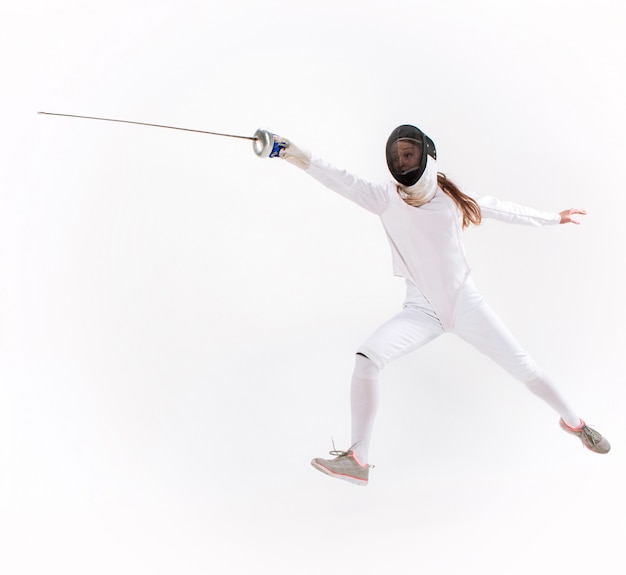 Man wearing fencing suit practicing with sword