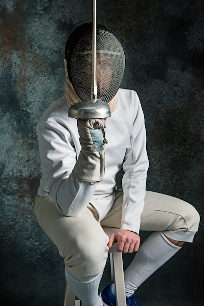 Free photo the man wearing fencing suit with sword