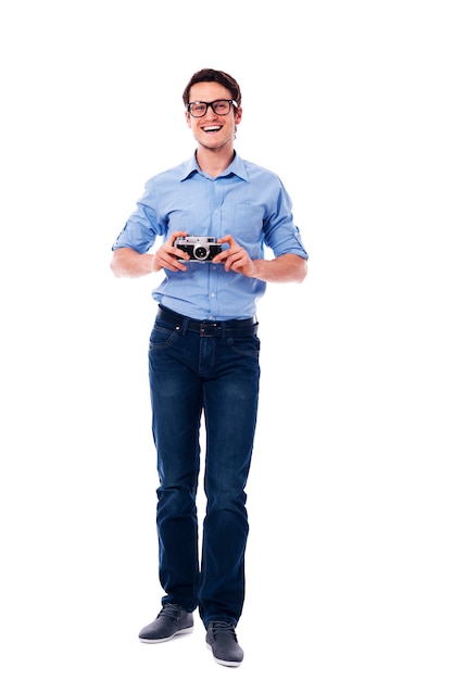 Man wearing glasses holding vintage camera