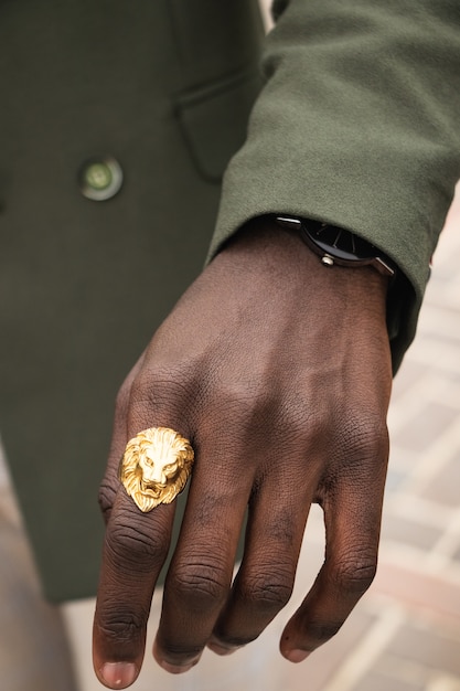 Man wearing golden lion ring