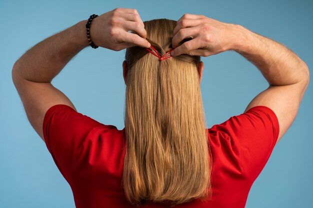 man wearing hair clips back view