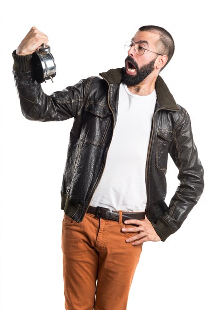 Man wearing a leather jacket holding vintage clock