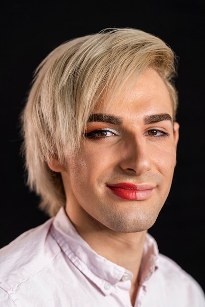 Free photo man wearing make-up on half his face