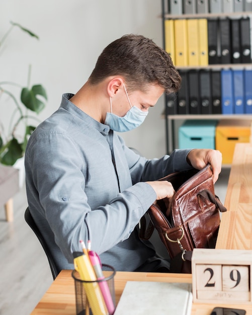 Man wearing mask in the office during pandemic