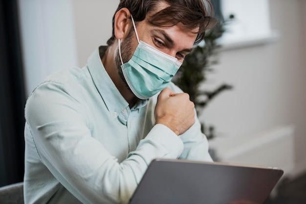 Foto gratuita uomo che indossa la mascherina medica al lavoro