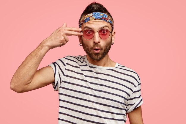 Man wearing pink sunglasses and colorful bandana