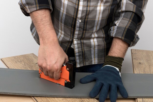 Man wearing protection gloves carpentry workshop concept