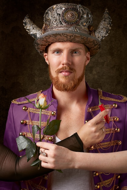 Man wearing purple coat and gold hat 