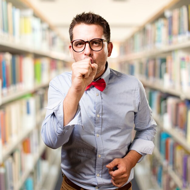 Man wearing a red bow tie. Coughing.