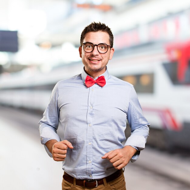 Man wearing a red bow tie. Looking happy.