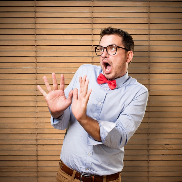 Man wearing a red bow tie. Looking scared.