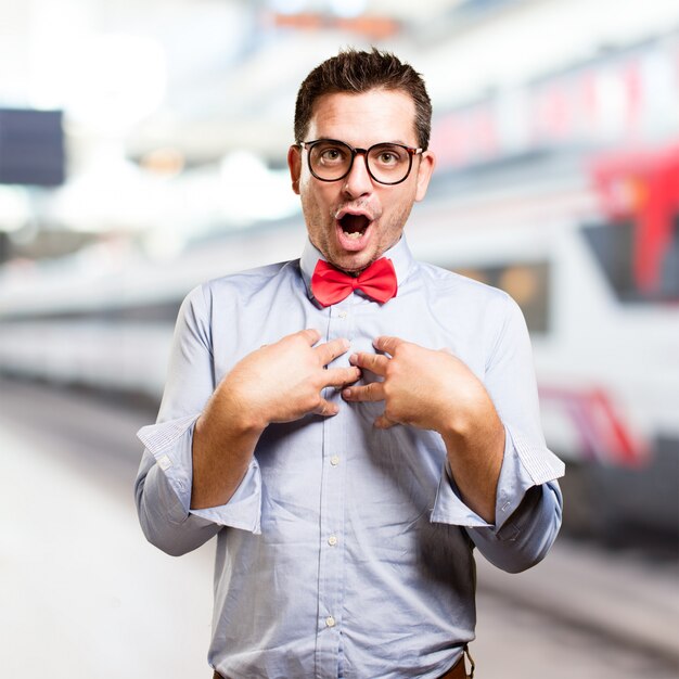 Man wearing a red bow tie. Looking surprised.