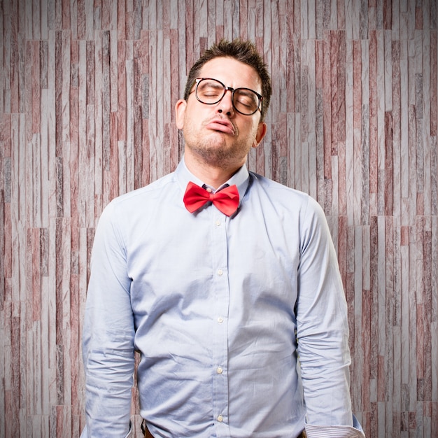 Man wearing a red bow tie. Looking tired.