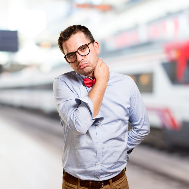 Man wearing a red bow tie. Looking tired.