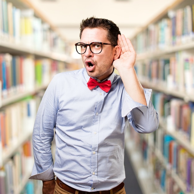 Man wearing a red bow tie. Paying attention to a noise.