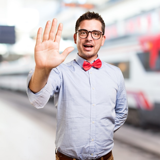 Man wearing a red bow tie. Showing his palm.